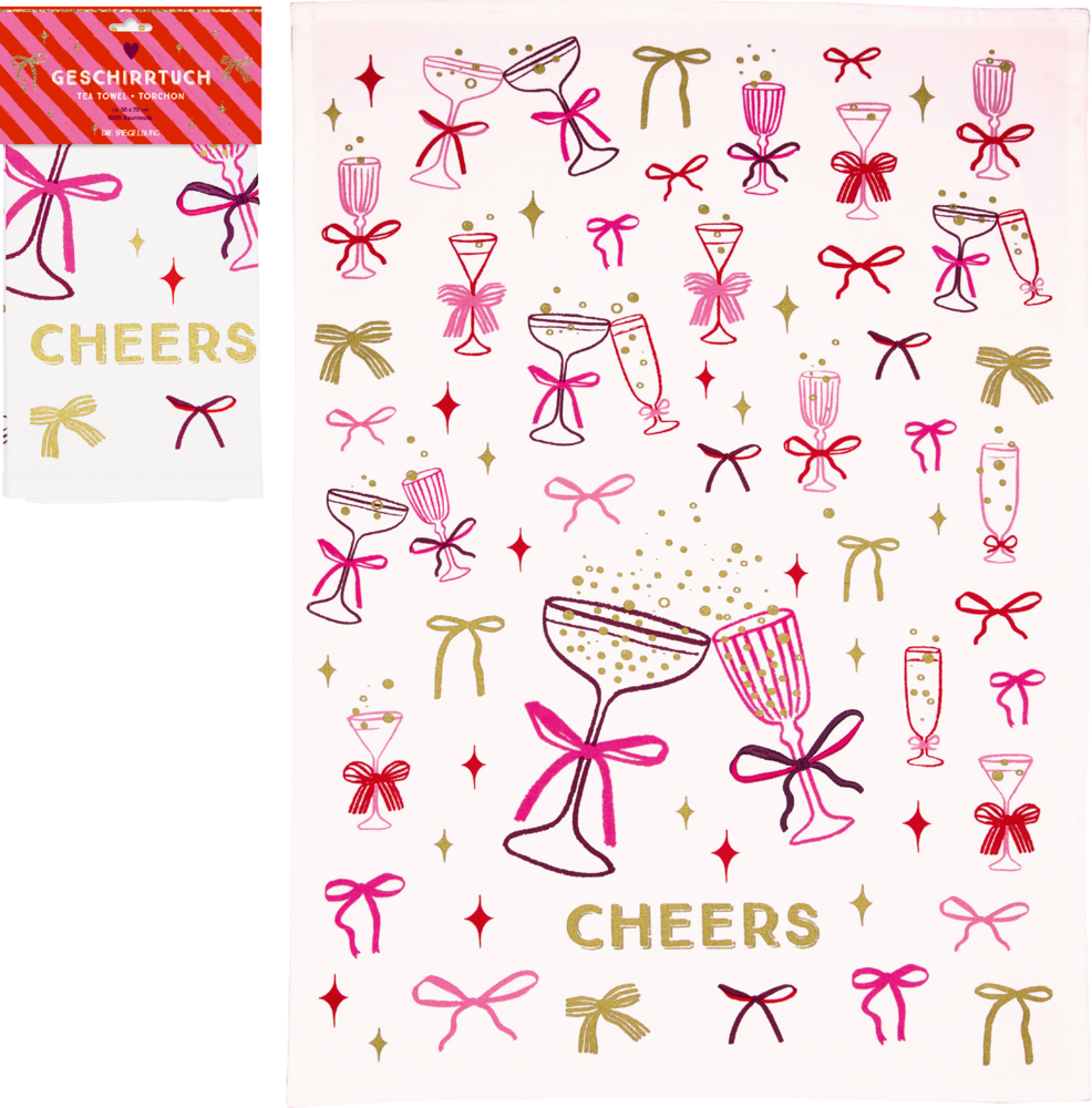 Weißes Geschirrtuch mit goldfarbenem Schriftzug „CHEERS“, Gläsern mit Schleifen und kleinen Sternmotiven in Pink, Rot und Gold, daneben ein verpacktes Geschirrtuch.