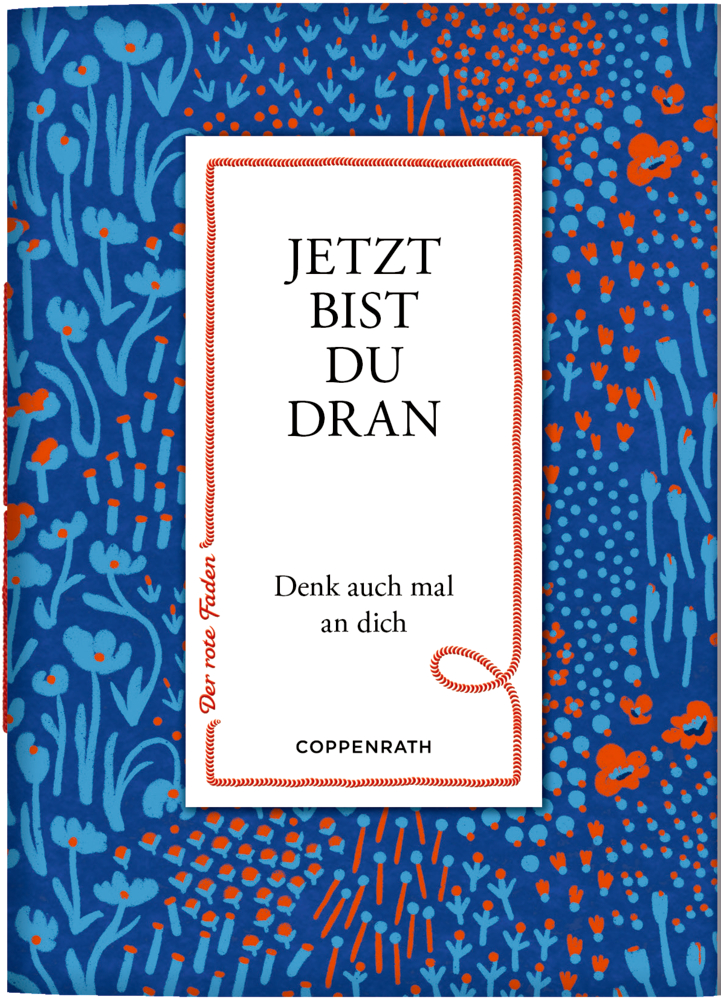 Buchcover mit dem Text „JETZT BIST DU DRAN“ auf einem blau-roten Hintergrund mit Blumenmuster.