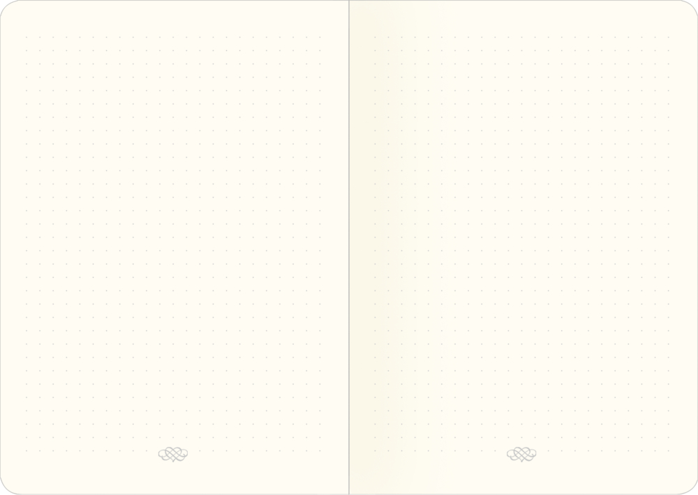 Offenliegendes Notizbuch mit Punkteraster auf cremefarbenem Papier.